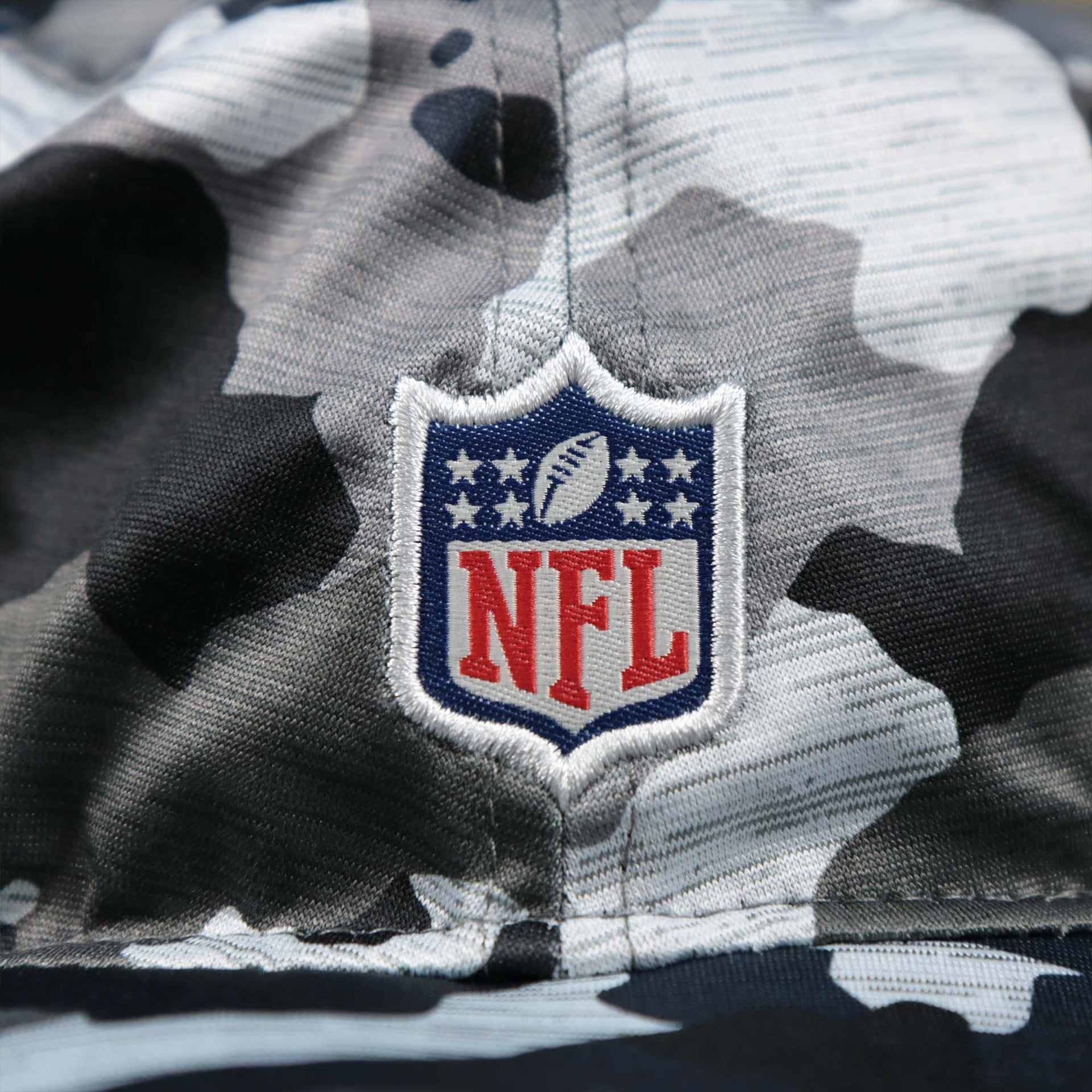 The NFL Logo on the New England Patriots NFL Summer Training Camp 2022 Camo Bucket Hat | Navy Bucket Hat