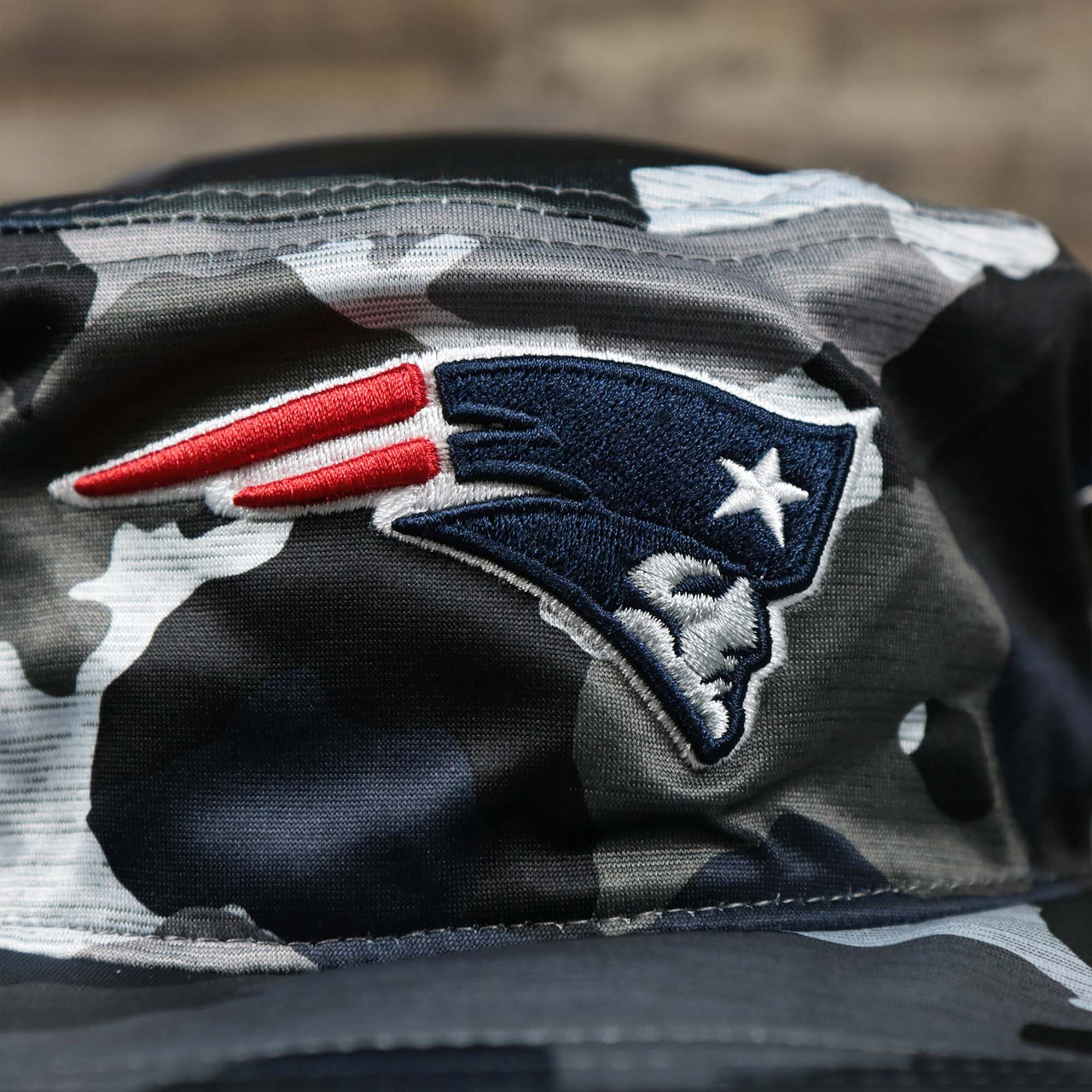 The Patriots Logo on the New England Patriots NFL Summer Training Camp 2022 Camo Bucket Hat | Navy Bucket Hat