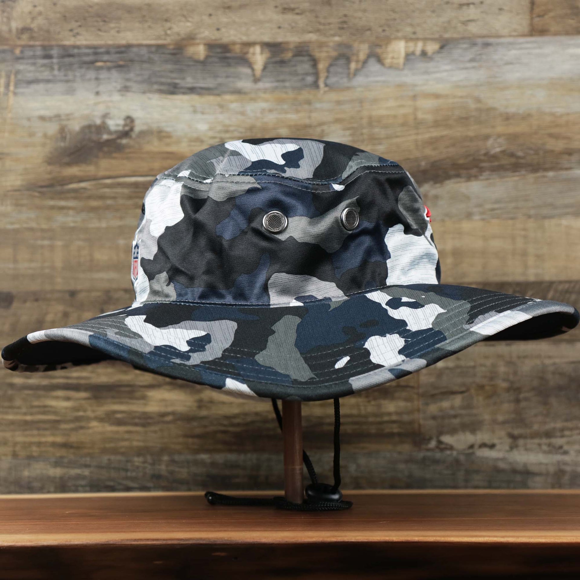The wearer's right on the New England Patriots NFL Summer Training Camp 2022 Camo Bucket Hat | Navy Bucket Hat