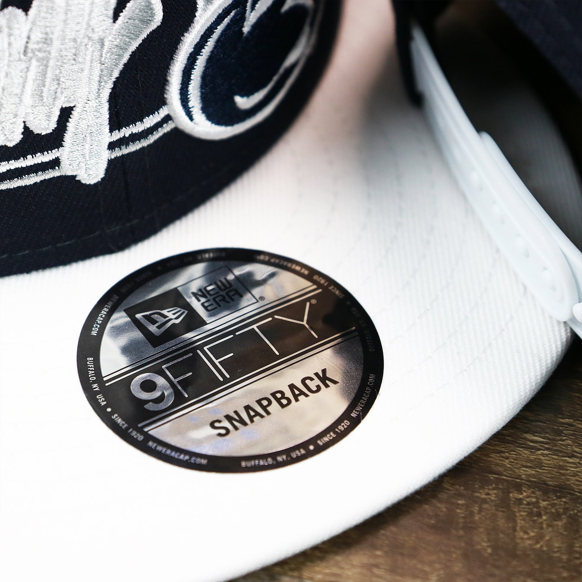 The 9Fifty Sticker on the Penn State Nittany Lions Team Script Gray Bottom 9Fifty Snapback | Navy Blue And White Snap Cap