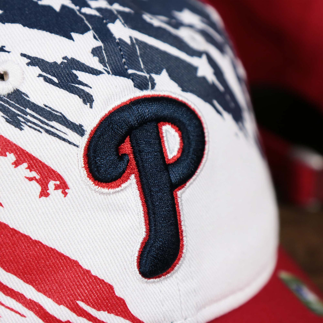 The Phillies logo on the Youth Stars And Stripes Philadelphia Phillies 4th of July 9Twenty | New Era Red OSFM