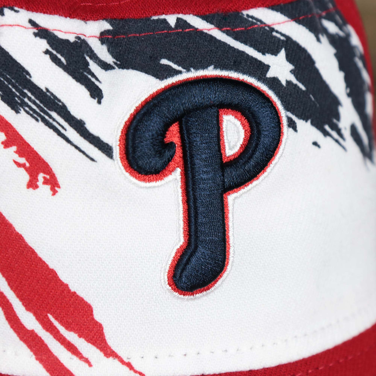 The Phillies logo on the Stars And Stripes Philadelphia Phillies 4th of July Bucket Hat | New Era Red OSFM