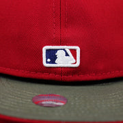 The MLB Batterman Logo on the Philadelphia Phillies Alpha Industries Side Patch Army Green Undervisor 59FIfty Fitted Cap With Hangtag | Red 59FIfty Cap