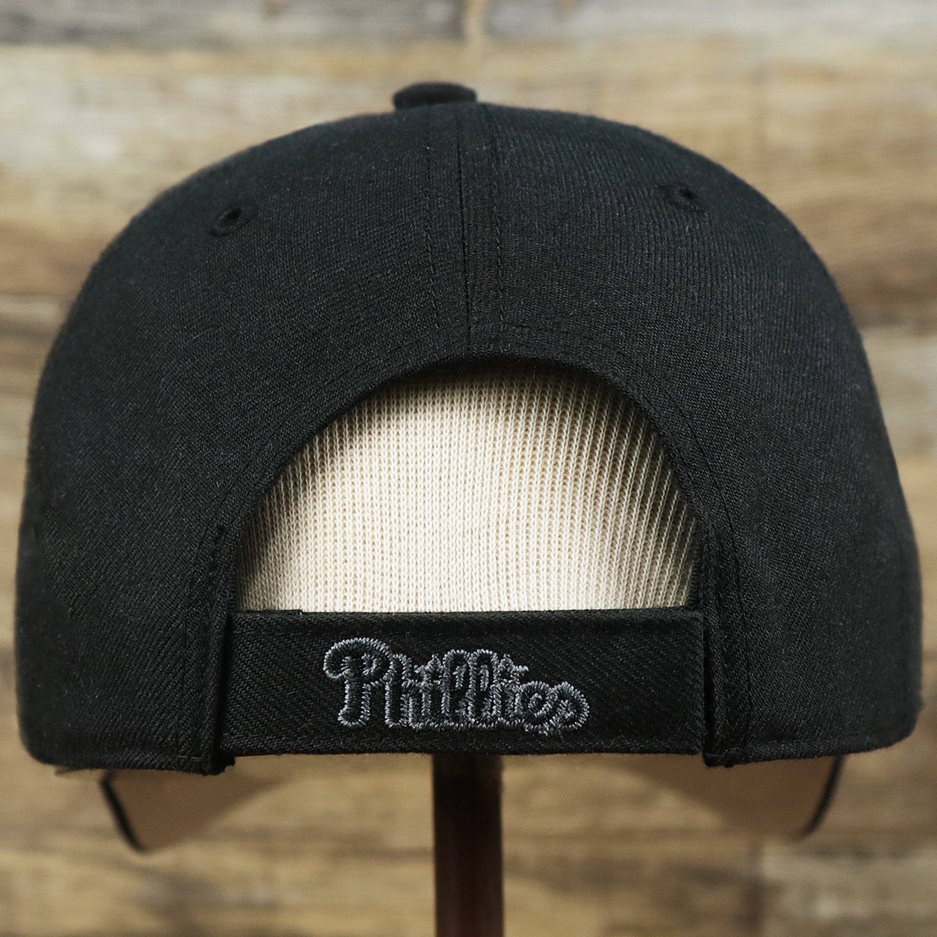 The backside of the Philadelphia Phillies Gray Logo Gray Bottom Wool Dad Hat | Black Wool Dad Hat