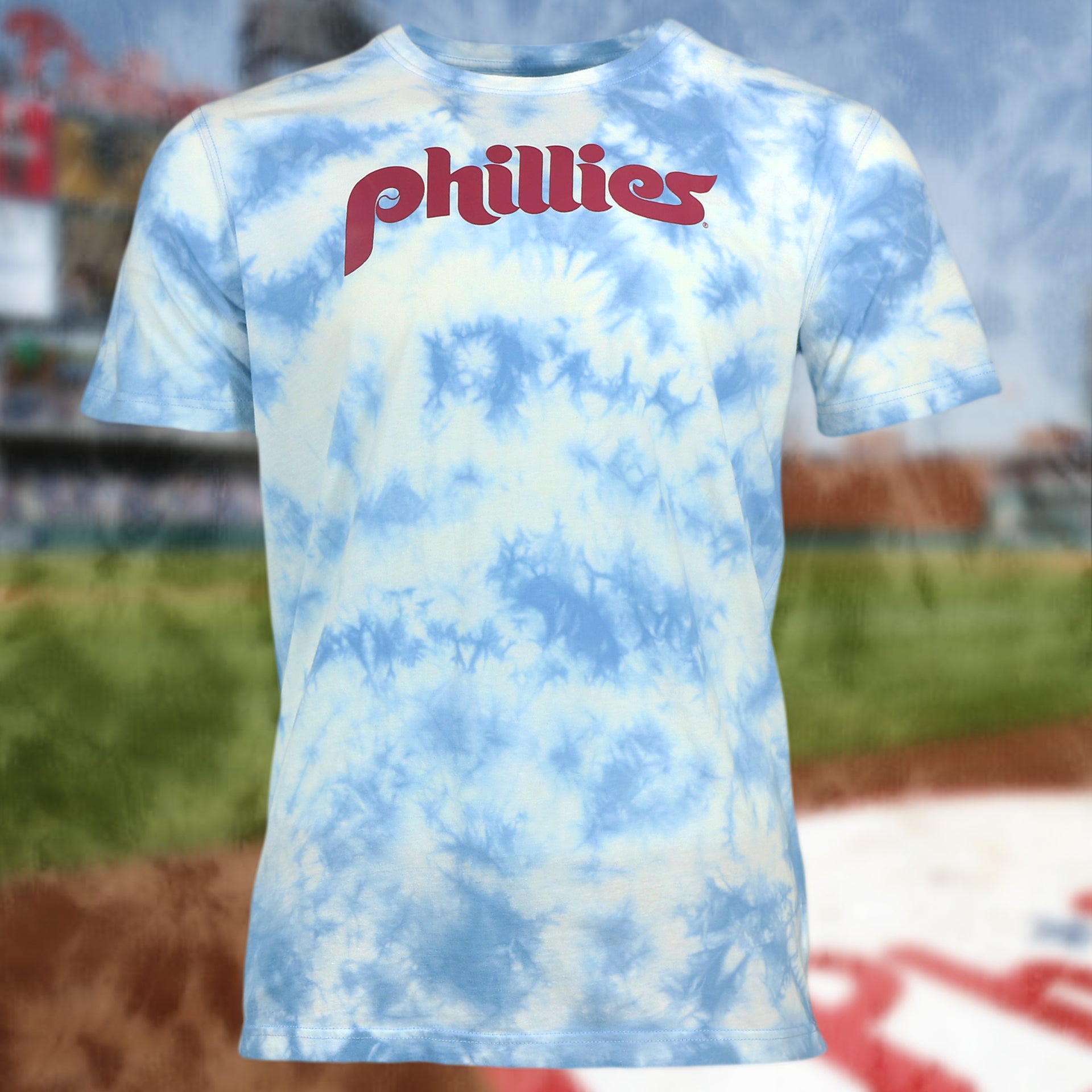 front of the Philadelphia Phillies Vintage Phillies Wordmark Tie-Dye MLB T-Shirt | Columbia Blue Tie-Dye T-shirt