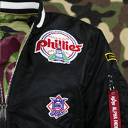 The Liberty Hall Phillies Side Patch and the National Baseball League Side Patch on the Cooperstown Philadelphia Phillies MLB Patch Alpha Industries Reversible Bomber Jacket With Camo Liner | Black Bomber Jacket