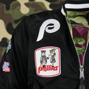 The Phillies Cooperstown Logo and the Phil and Phyllis Logo Side Patch on the Cooperstown Philadelphia Phillies MLB Patch Alpha Industries Reversible Bomber Jacket With Camo Liner | Black Bomber Jacket