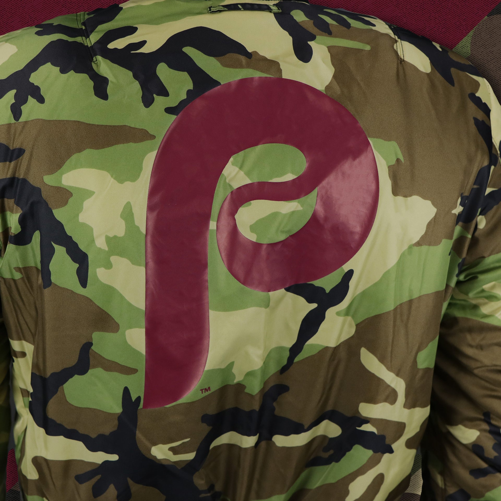 The backside of the Cooperstown Philadelphia Phillies MLB Patch Alpha Industries Reversible Bomber Jacket With Camo Liner | Black Bomber Jacket