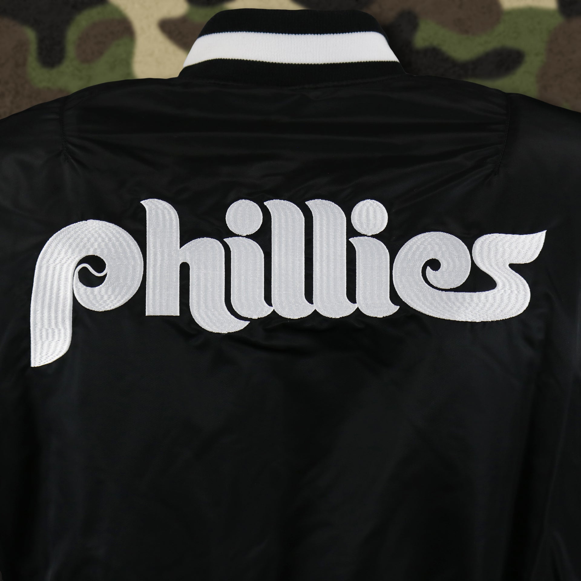 The Phillies Wordmark on the Cooperstown Philadelphia Phillies MLB Patch Alpha Industries Reversible Bomber Jacket With Camo Liner | Black Bomber Jacket