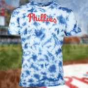 front side of the Philadelphia Phillies Current Phillies Wordmark Tie-Dye MLB T-Shirt | Columbia Blue Tie-Dye Tshirt