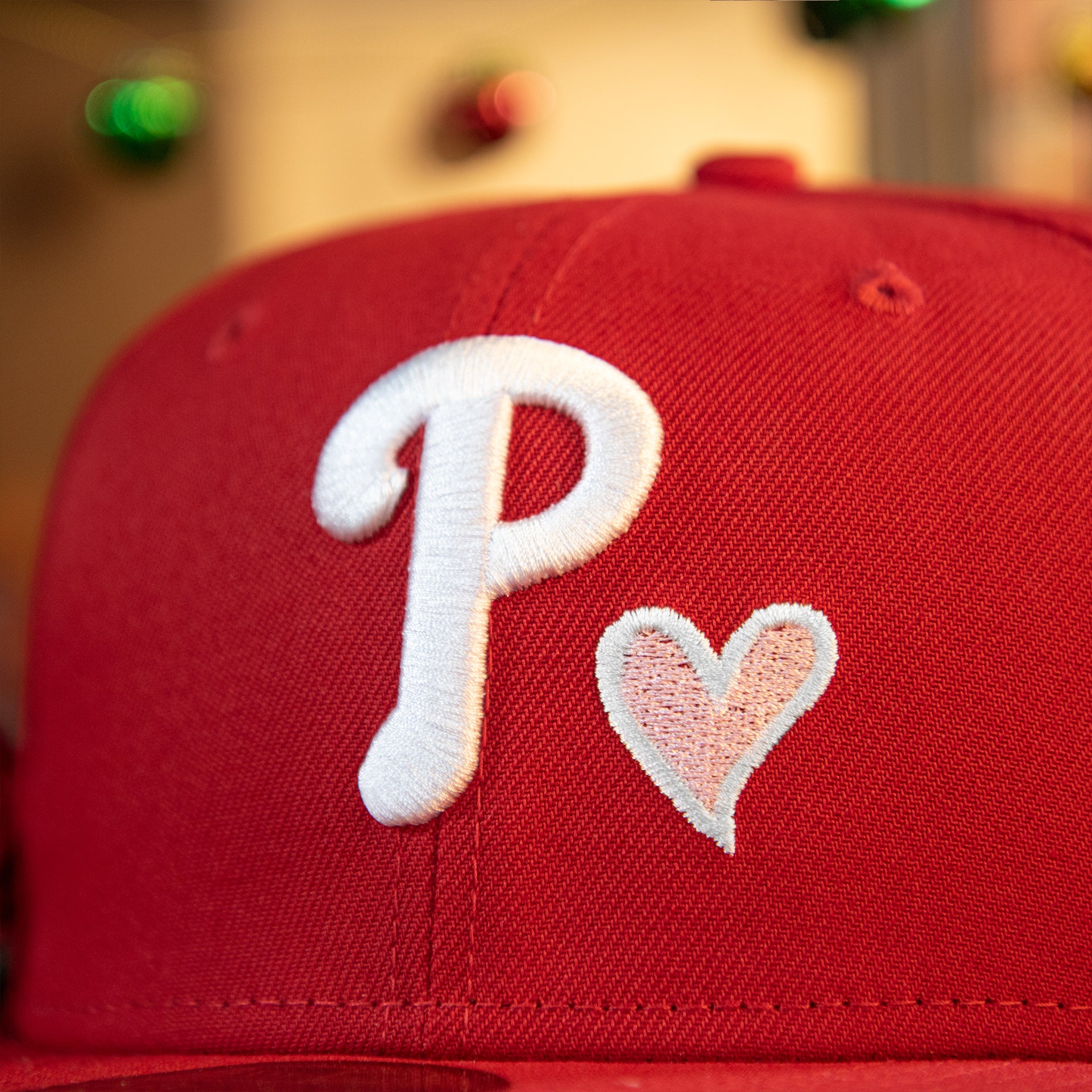 phillies and heart logo on the Philadelphia Phillies 2008 World Series Pink Heart Patch 59fifty Pink Brim Fitted Hat | Red
