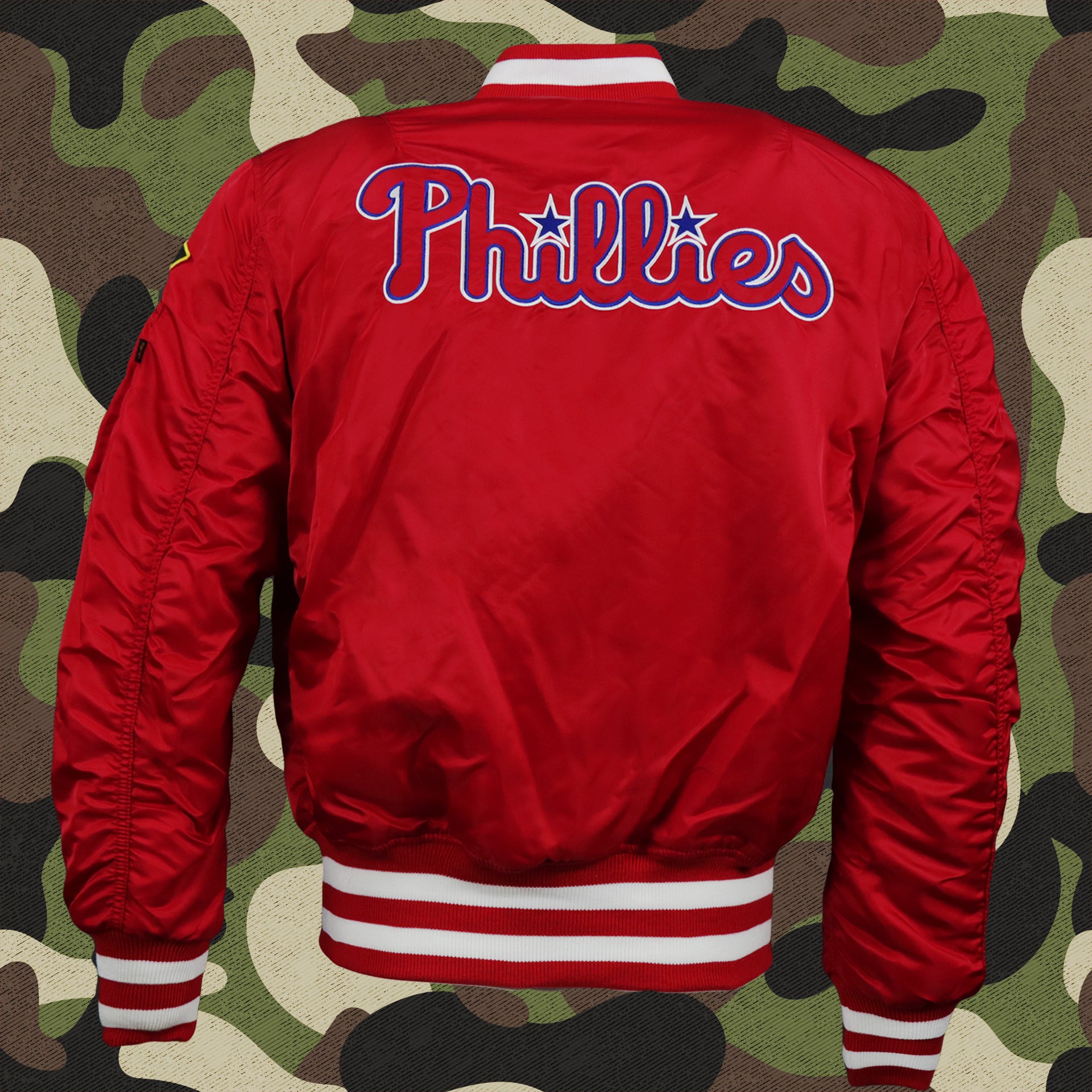 The backside of the Philadelphia Phillies MLB Patch Alpha Industries Reversible Bomber Jacket With Camo Liner | Red Bomber Jacket
