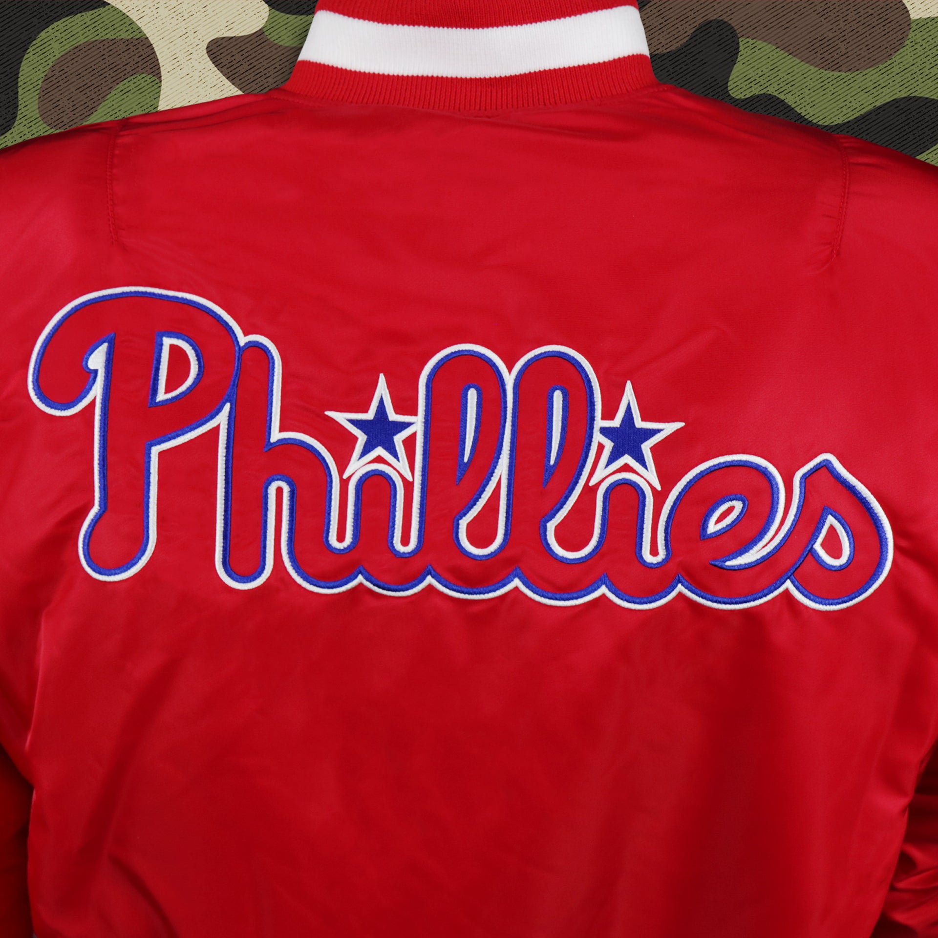 The Phillies Wordmark Logo on the Philadelphia Phillies MLB Patch Alpha Industries Reversible Bomber Jacket With Camo Liner | Red Bomber Jacket