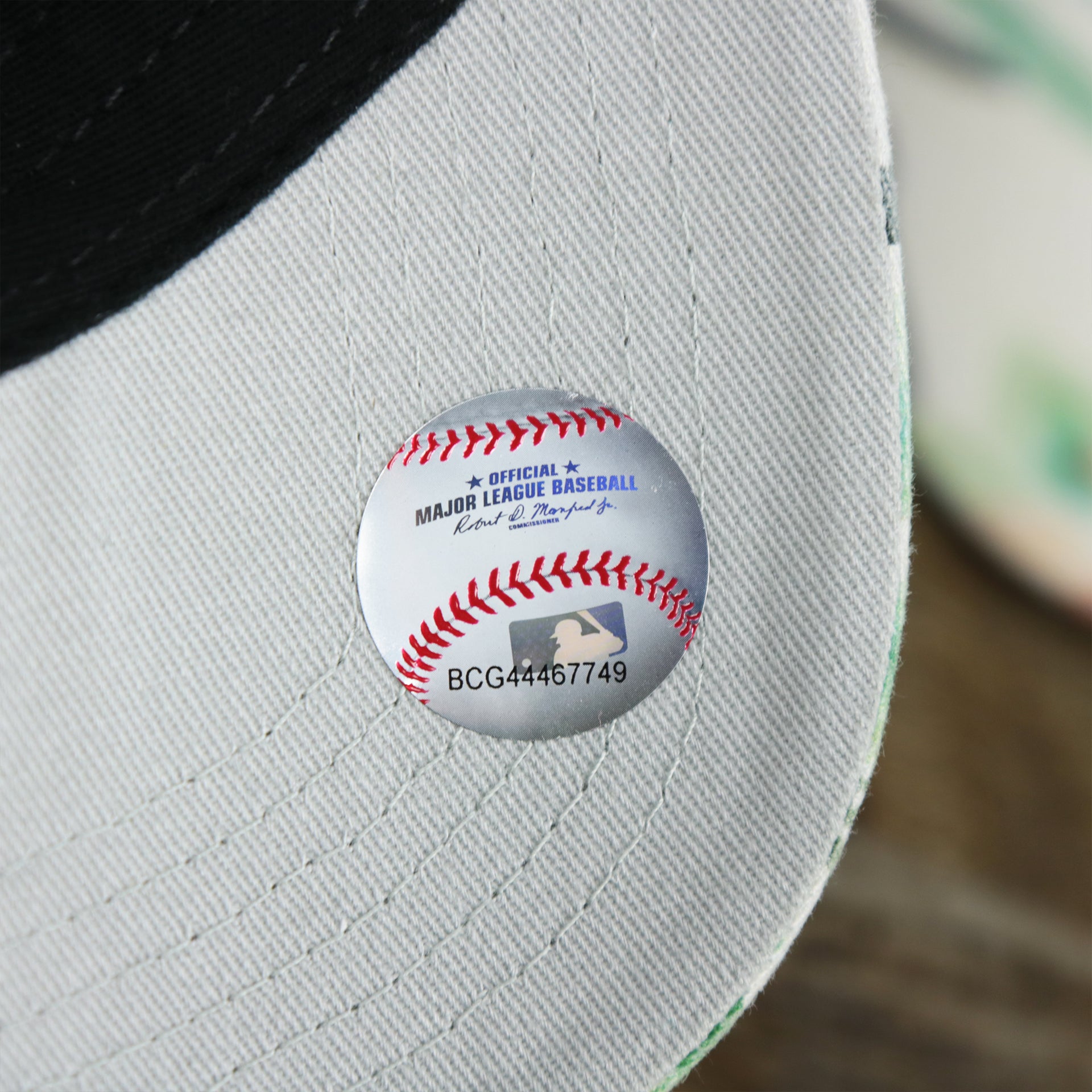 The MLB Baseball Sticker on the Women’s Philadelphia Phillies Floral Print Gray Bottom Dad Hat | White Dad Hat