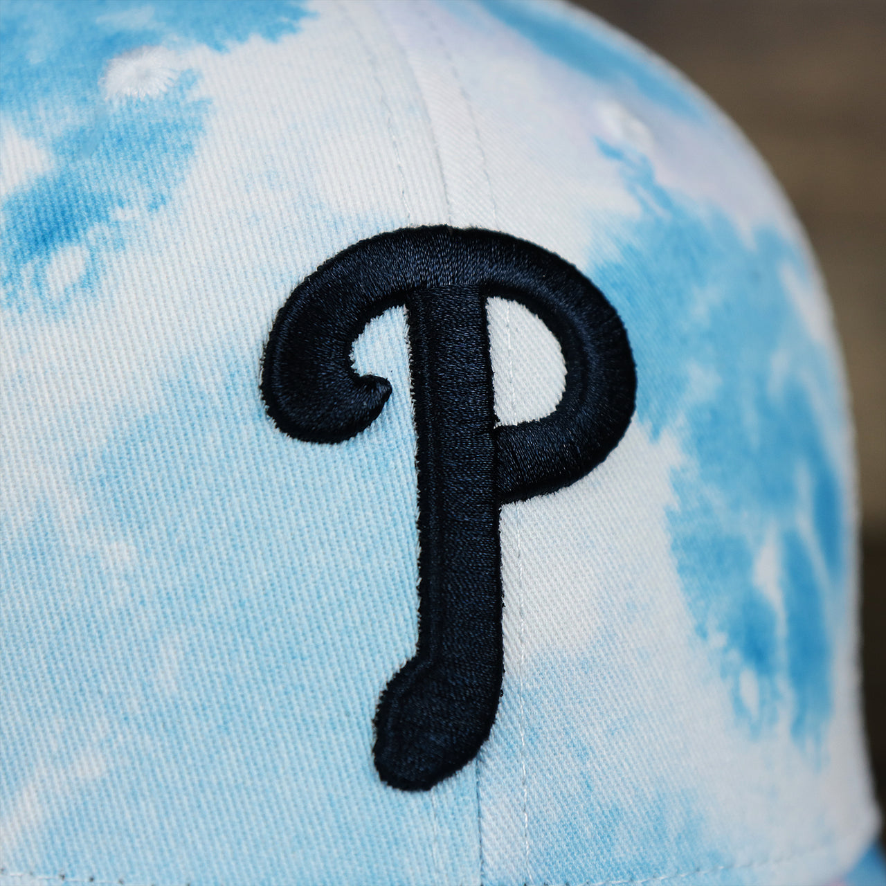 The Phillies Logo on the Women’s Philadelphia Phillies Tie Dye Print Gray Bottom Mesh Trucker Hat | White Mesh Snapback