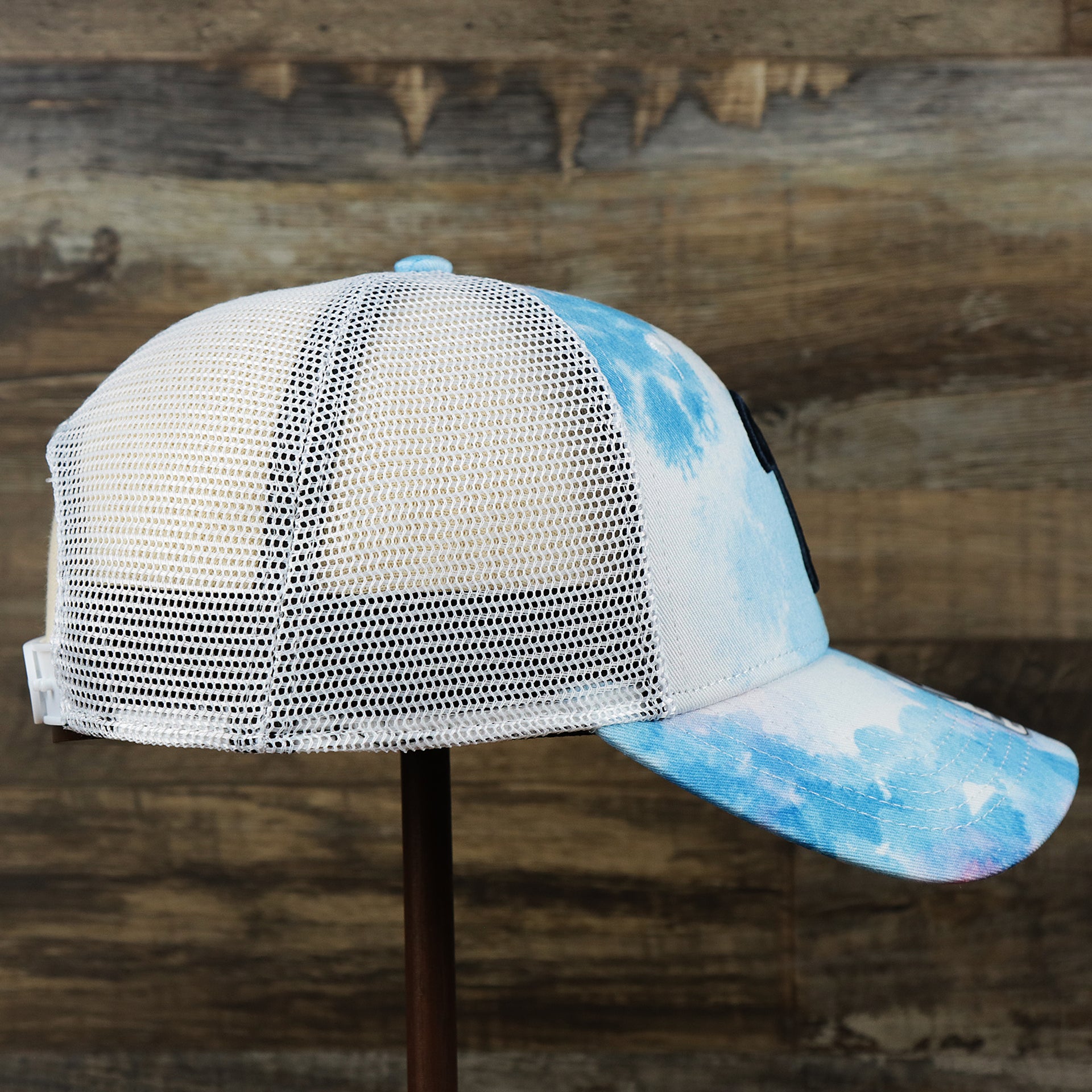 The wearer's right on the Women’s Philadelphia Phillies Tie Dye Print Gray Bottom Mesh Trucker Hat | White Mesh Snapback
