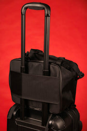 The backside of the Black Box Portable Hanging Sneaker Bag For Travel and Storage With Clear Window on a suit case