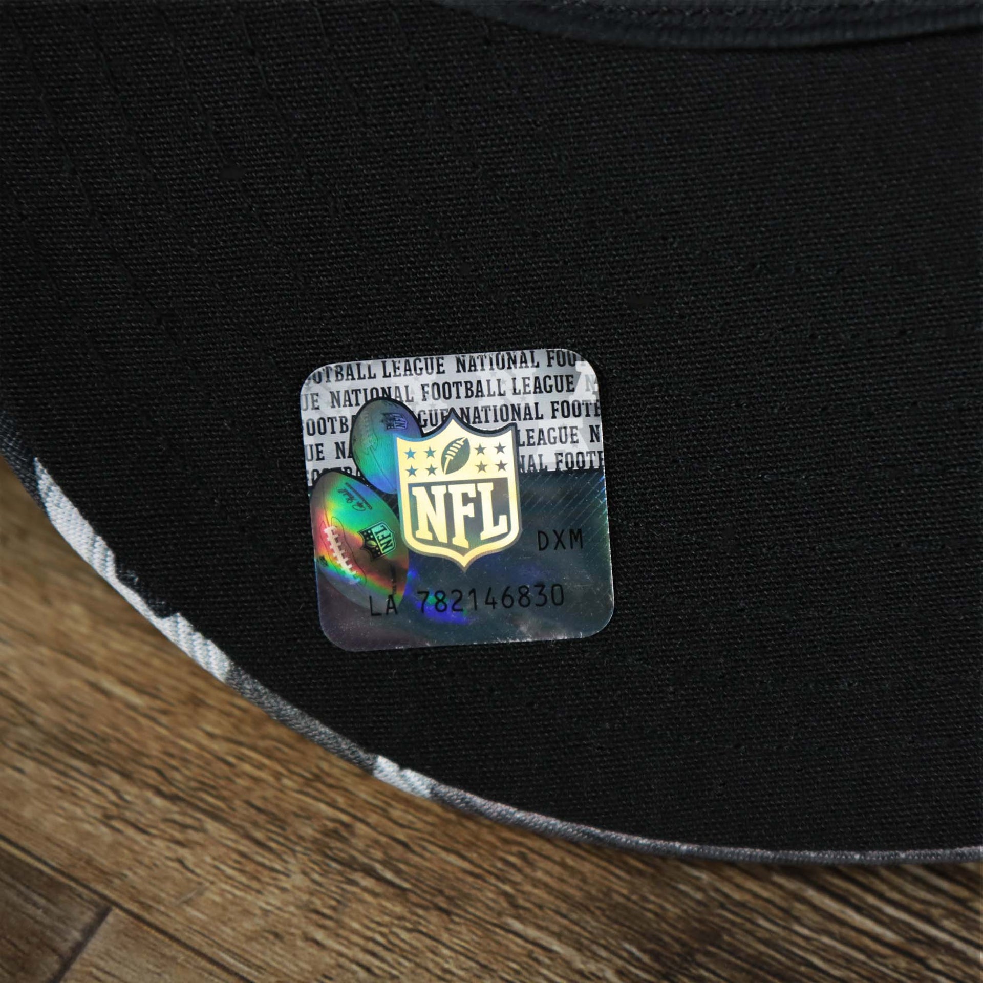 The NFL Sticker on the visor of the Los Angeles Raiders NFL OnField Summer Training 2022 Camo 9Fifty Snapback | Black Camo 9Fifty