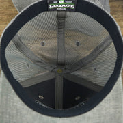 The inside of the OCNJ Ocean City 1879 Sunset Wave Logo Mesh Stretch FIt Hat | Dark Green And Dark Grey Stretch Fit Hat