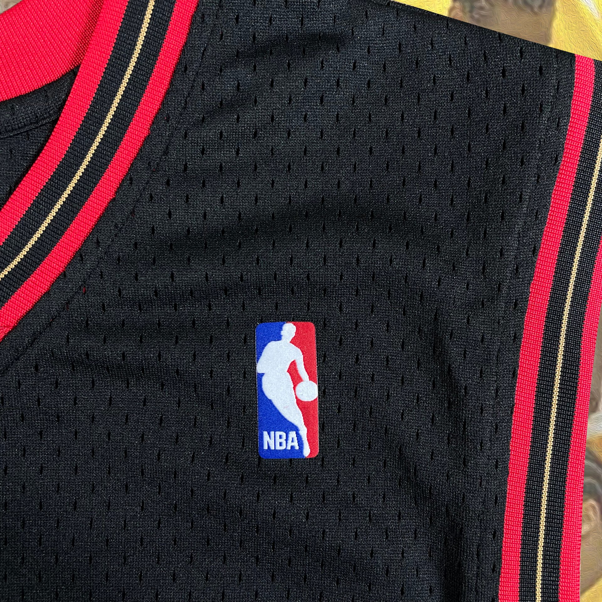 Close up of the NBA logo on the Allen Iverson 2000-2001 Philadelphia 76ers NBA Playoffs Throwback SwingMan Jersey | Black, Mitchell and Ness