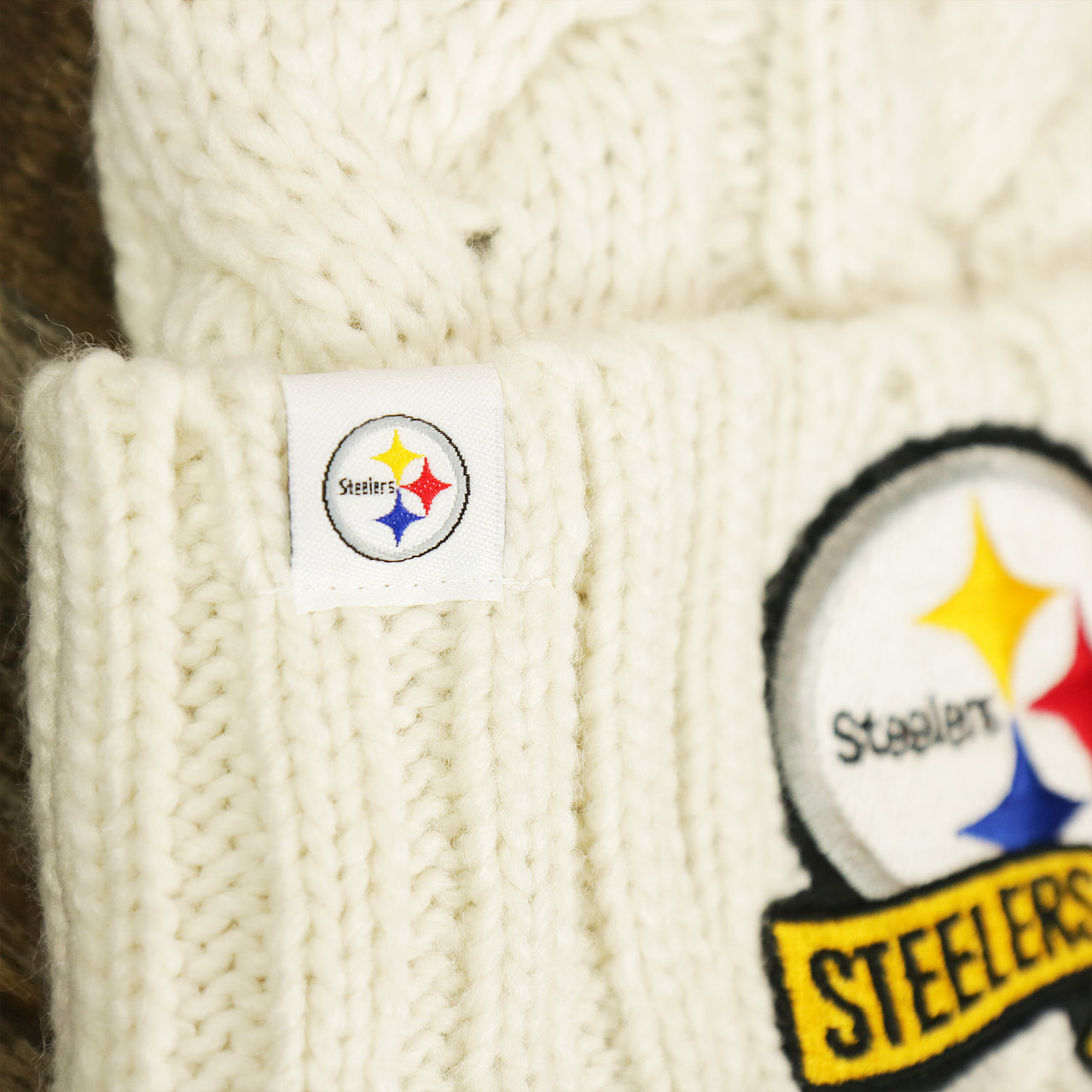 The Steelers Tag on the Women’s Philadelphia Steelers 2022 AFC Cuffed Winter Knit Meeko Pom Pom Beanie | Women’s White Winter Beanies