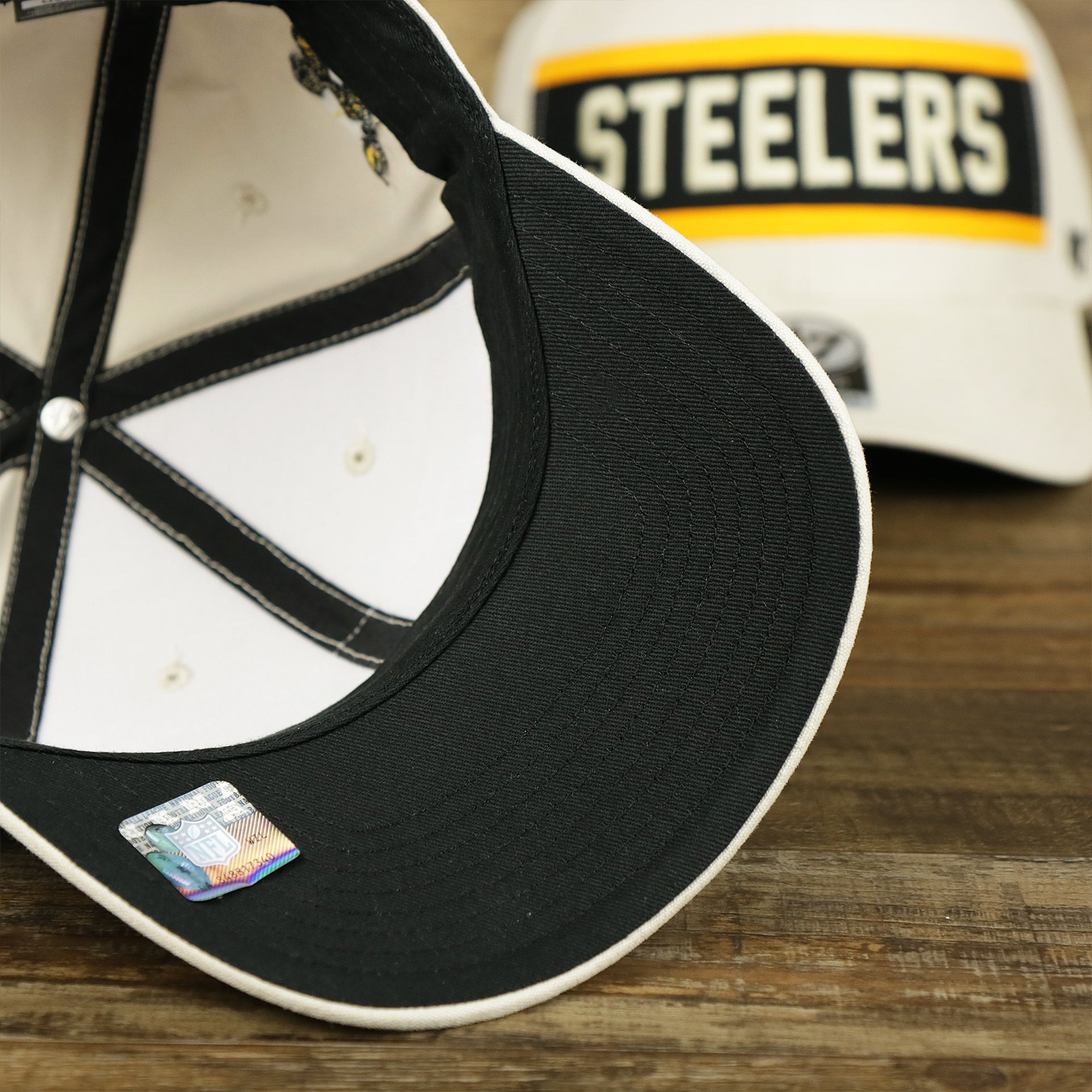 The undervisor on the Throwback Pittsburgh Steelers Striped Wordmark Legacy Steelers Side Patch Crossroad Dad Hat | Bone Dad Hat