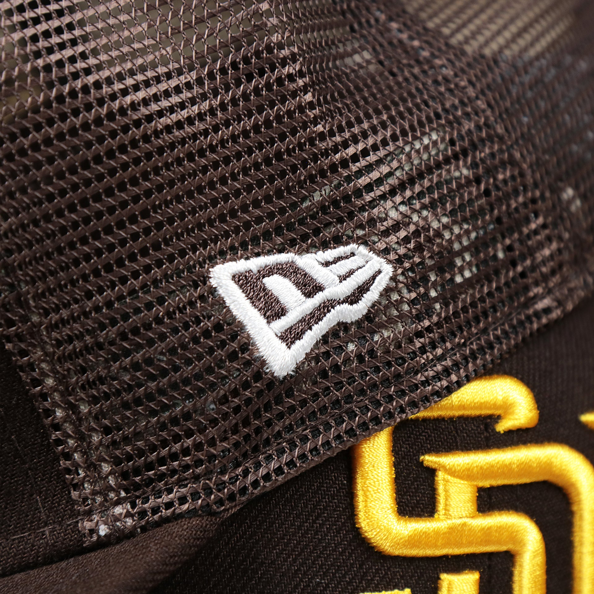 The New Era  Logo on the San Diego Padres Metallic All Star Game MLB 2022 Side Patch 9Fifty Mesh Snapback | ASG 2022 Brown Trucker Hat