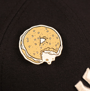 The New York Bagel Fitted Cap Pin | Enamel Pin For Hat on a cap