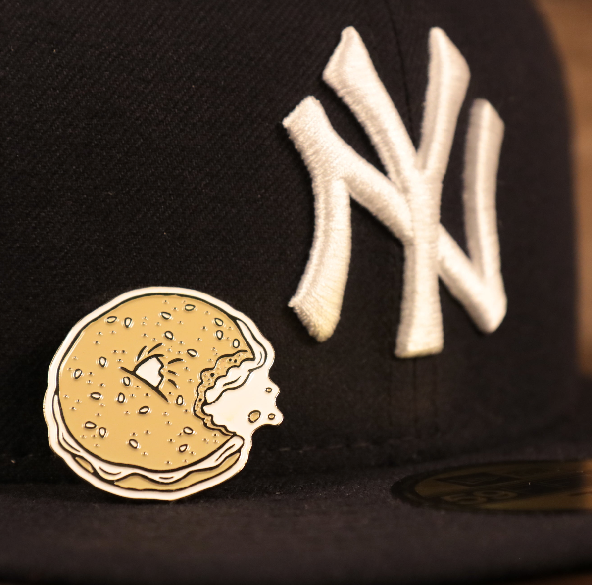 The New York Bagel Fitted Cap Pin | Enamel Pin For Hat on the brim