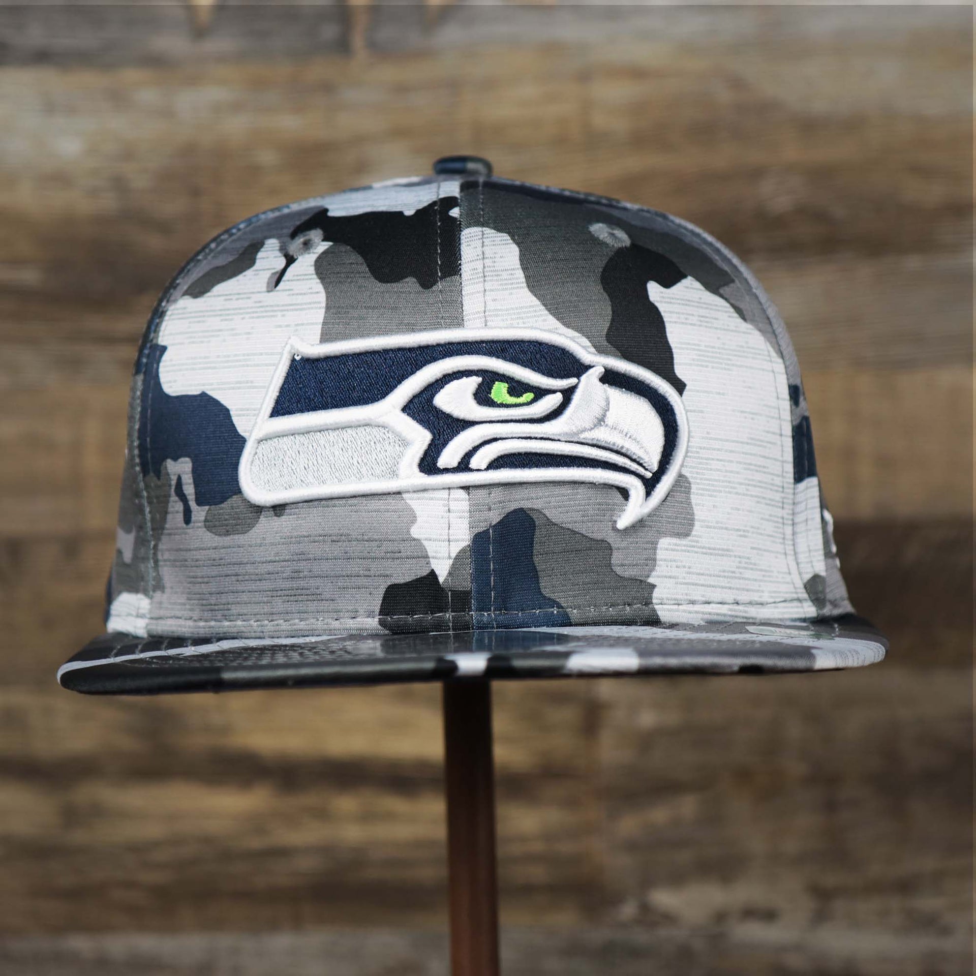 The front of the Seattle Seahawks NFL OnField Summer Training 2022 Camo 9Fifty Snapback | Navy Blue Camo 9Fifty