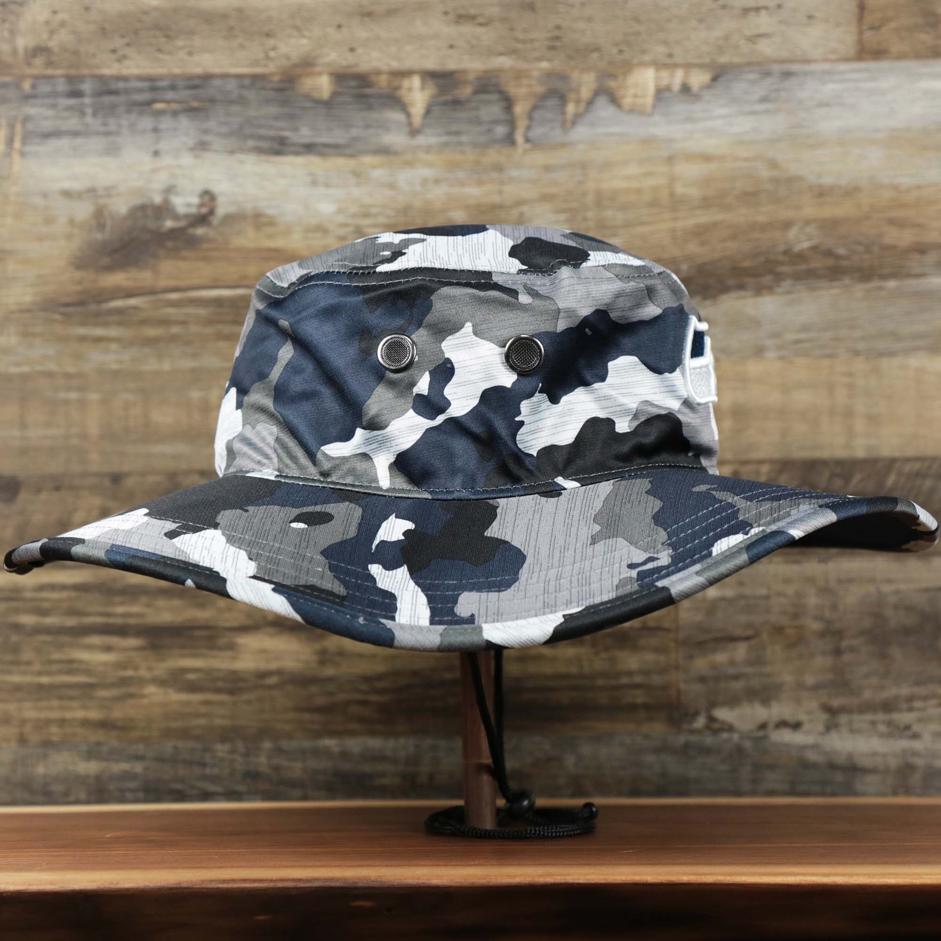 The wearer's right on the Seattle Seahawks NFL Summer Training Camp 2022 Camo Bucket Hat | Navy Bucket Hat
