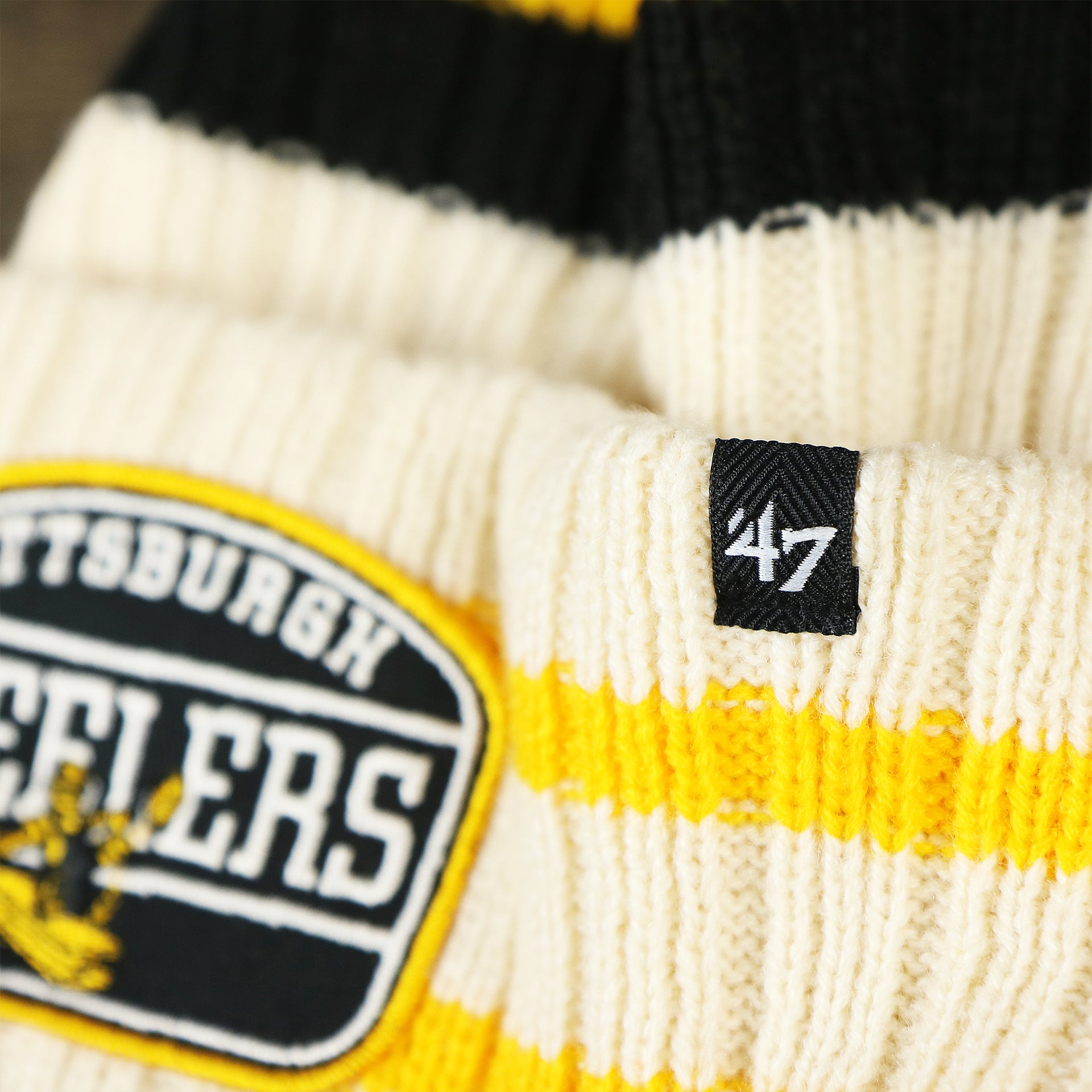 The 47 Brand Tag on the Throwback Pittsburgh Steelers Legacy 1962 Steelers Patch Pom Pom Beanie | Natural Beanie