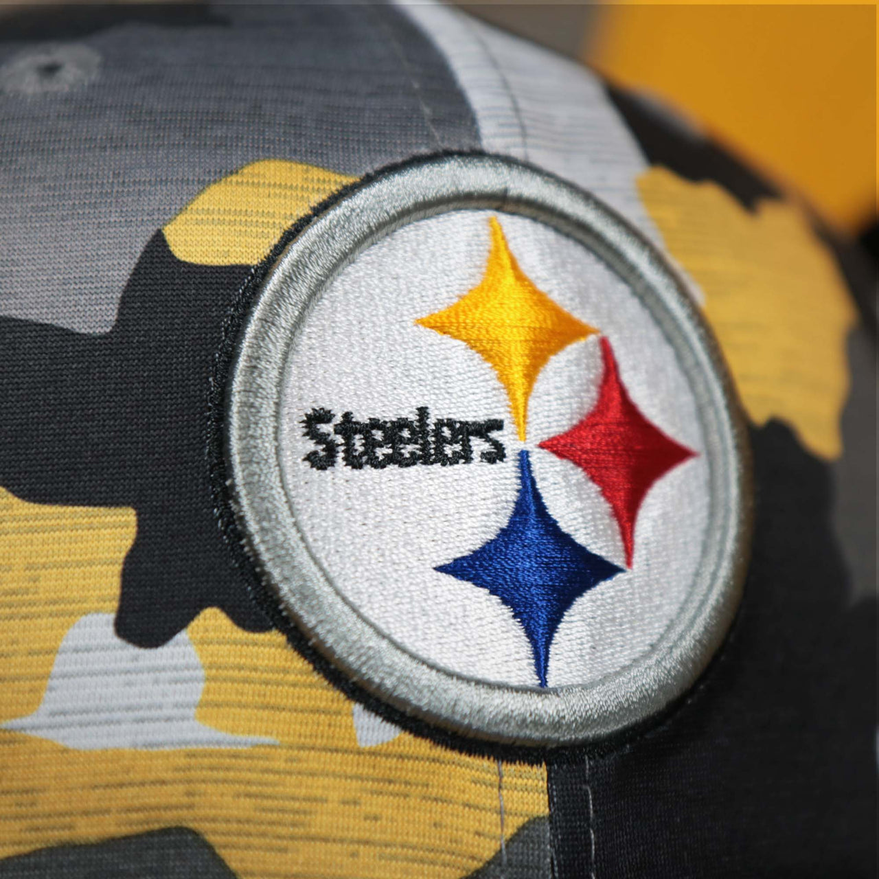 The Steelers Logo on the Pittsburgh Steelers NFL OnField Summer Training 2022 Camo 9Fifty Snapback | Yellow Camo 9Fifty