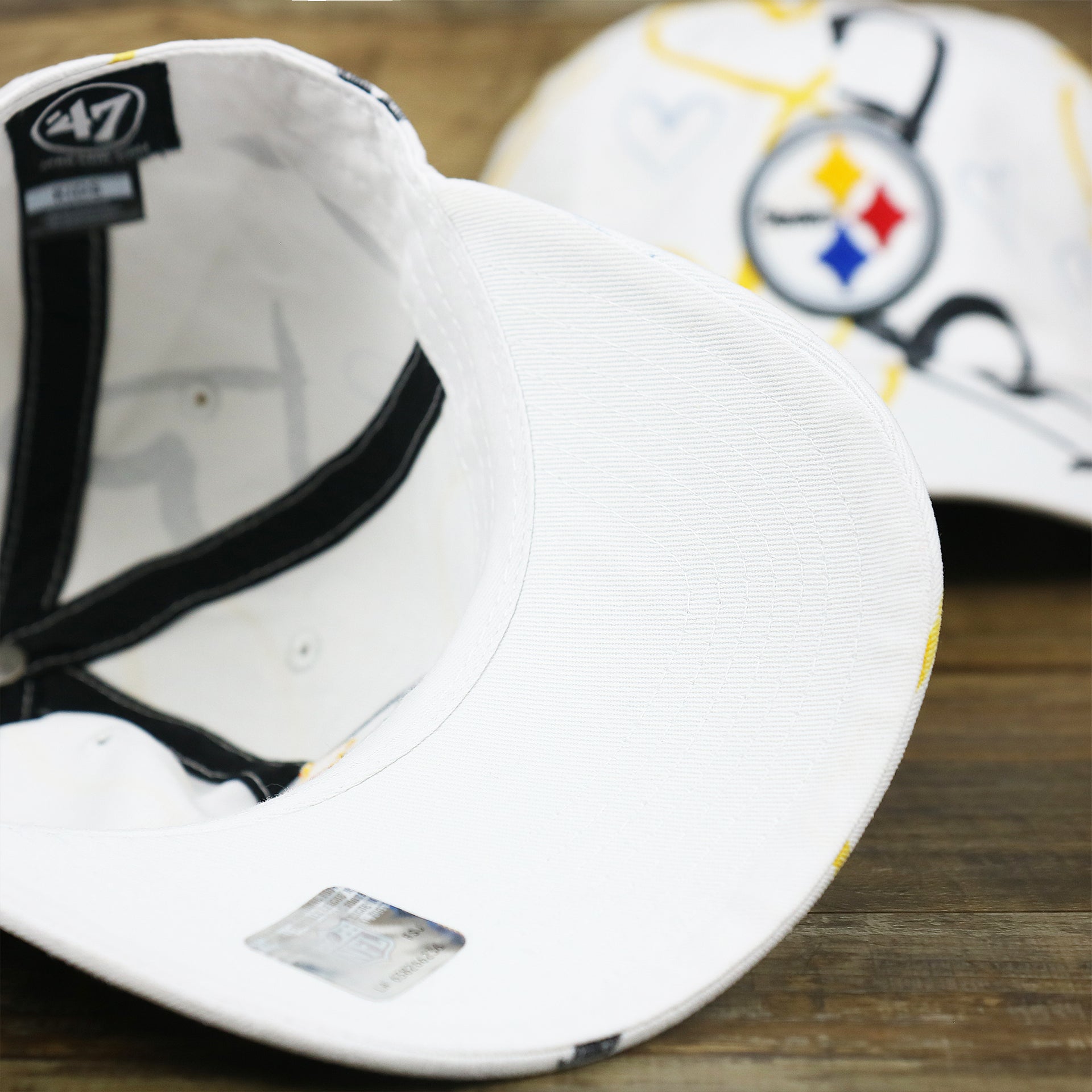 The undervisor on the Kids Pittsburgh Steelers Hearts All Over Print Dad Hat | White Kid’s Dad Hat