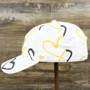 The wearer's left of the Kids Pittsburgh Steelers Hearts All Over Print Dad Hat | White Kid’s Dad Hat