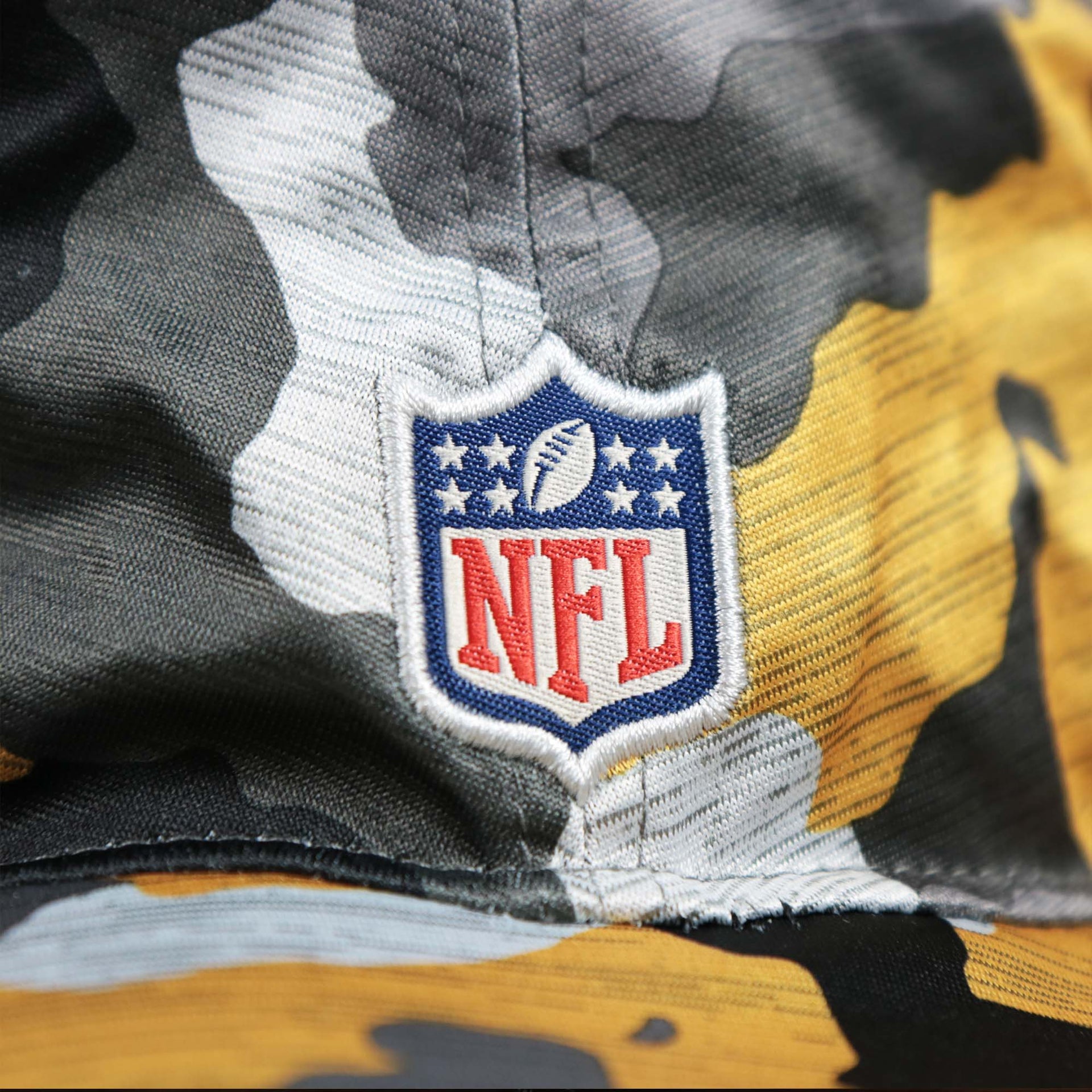 The NFl Logo on the Pittsburgh Steelers NFL Summer Training Camp 2022 Camo Bucket Hat | Yellow Bucket Hat