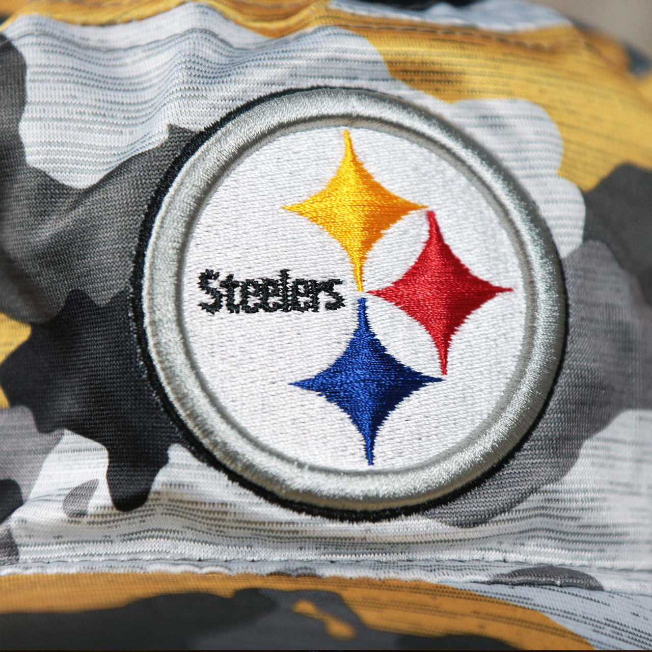 The Steelers Logo on the Pittsburgh Steelers NFL Summer Training Camp 2022 Camo Bucket Hat | Yellow Bucket Hat