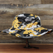 The wearer's right on the Pittsburgh Steelers NFL Summer Training Camp 2022 Camo Bucket Hat | Yellow Bucket Hat