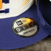 The 9Fifty Sticker on the Phoenix Suns NBA 2022 Draft Gray Bottom 9Fifty Snapback | New Era Cream/Purple