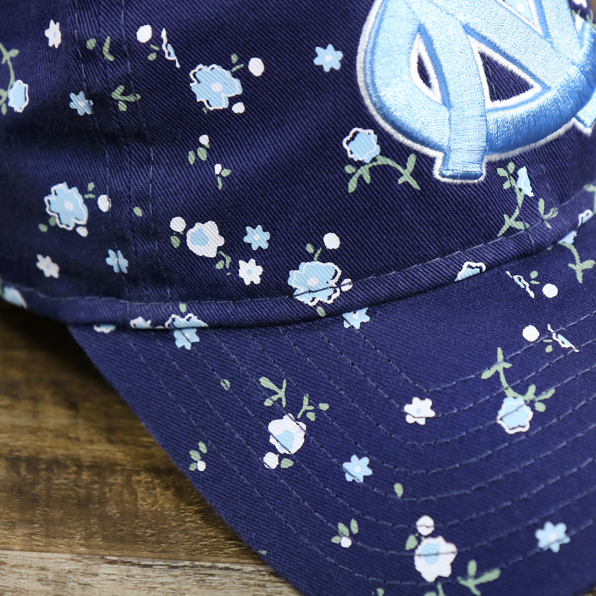 The Micro Floral Print on the Women’s North Carolina Tar Heels All Over Micro Floral Print 9Twenty Dad hat | Navy Blue 9Twenty Hat