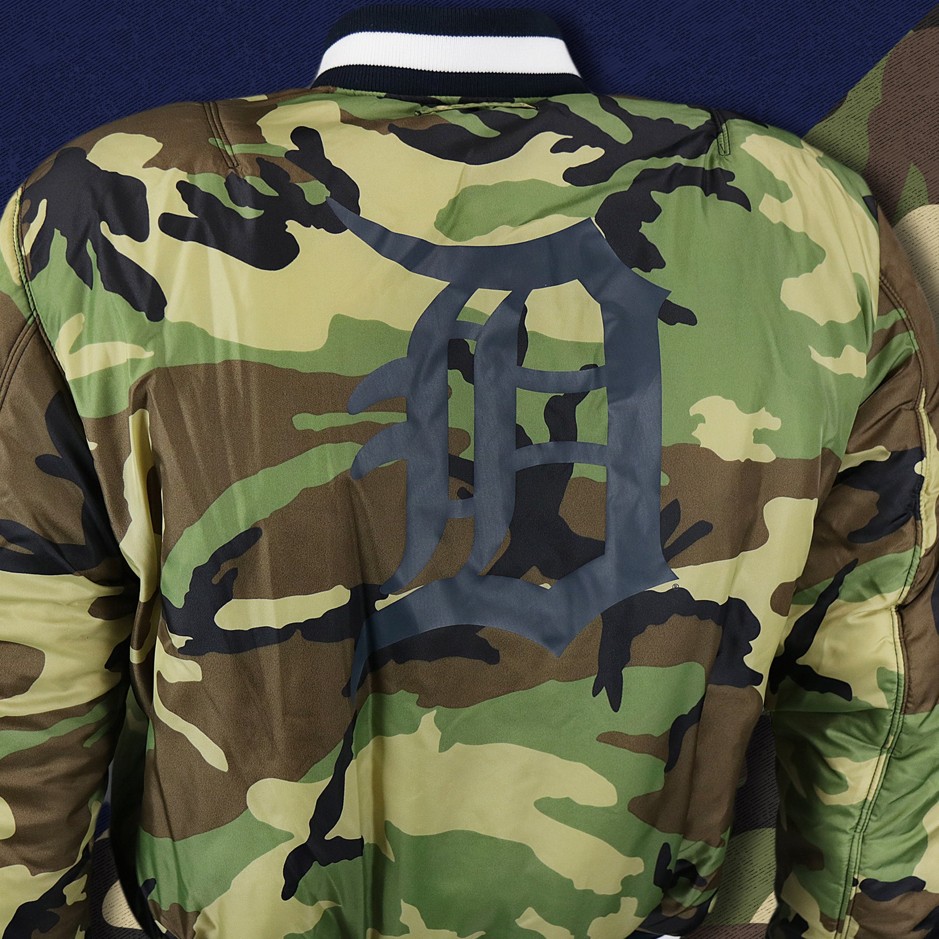 The backside of the Detroit Tigers MLB Patch Alpha Industries Reversible Bomber Jacket With Camo Liner | Navy Blue Bomber Jacket