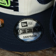 The 9Fifty Sticker on the Minnesota Timberwolves NBA 2022 Draft Gray Bottom 9Fifty Snapback | New Era Cream/Navy Blue