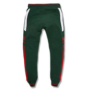 the green and red gucci colorway track pants are solid green and feature tapered ends with red accents
