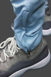 A close up of the zipper on the legging on the UNC Basketball Varsity Athletic Track Pants Jordan Craig