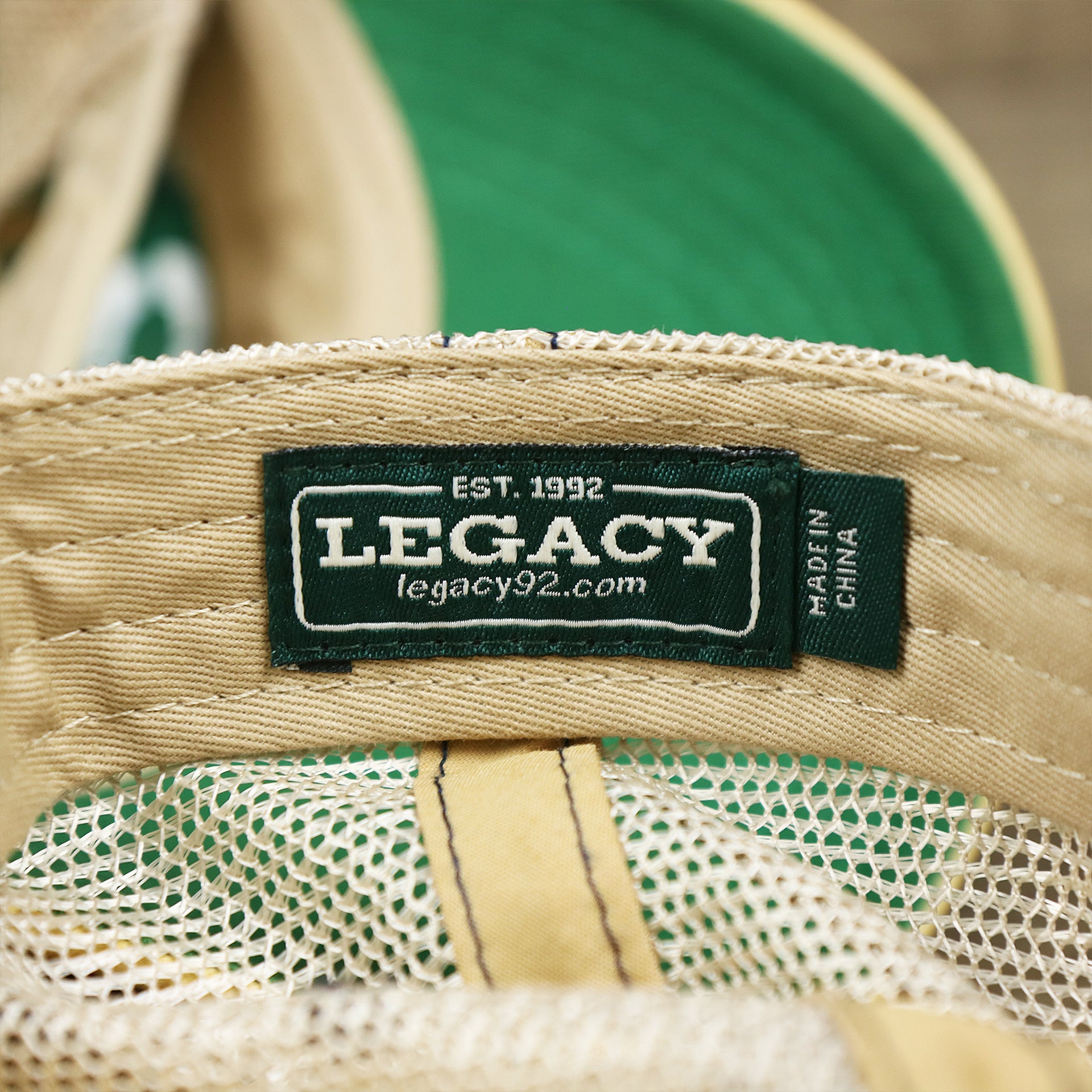 The Legacy Tag on the Wildwood New Jersey Leather Patch Shoreline Gradient Design Vintage Trucker Hat | Washed Gradient Trucker Hat