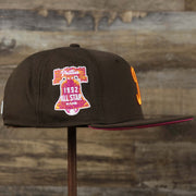 The wearer's right on the Cooperstown Philadelphia Phillies Coffee Shop 1952 All Star Game Liberty Bell Side Patch 59Fifty Fitted Cap | Donut Pack Walnut 59Fifty