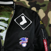 The Alternate White Sox Logo Patch and the American League Side Patch on the Chicago White Sox MLB Patch Alpha Industries Reversible Bomber Jacket With Camo Liner | Black Bomber Jacket