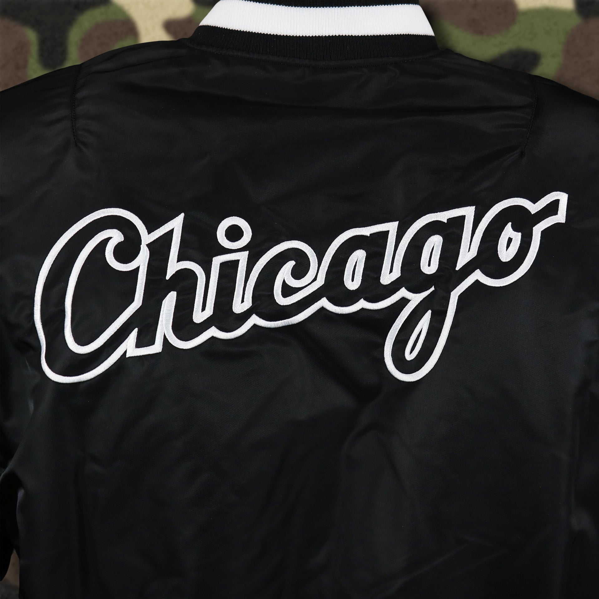 The Chicago Wordmark on the Chicago White Sox MLB Patch Alpha Industries Reversible Bomber Jacket With Camo Liner | Black Bomber Jacket