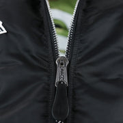 A close up of the zipper with Alpha engraved on the Chicago White Sox MLB Patch Alpha Industries Reversible Bomber Jacket With Camo Liner | Black Bomber Jacket