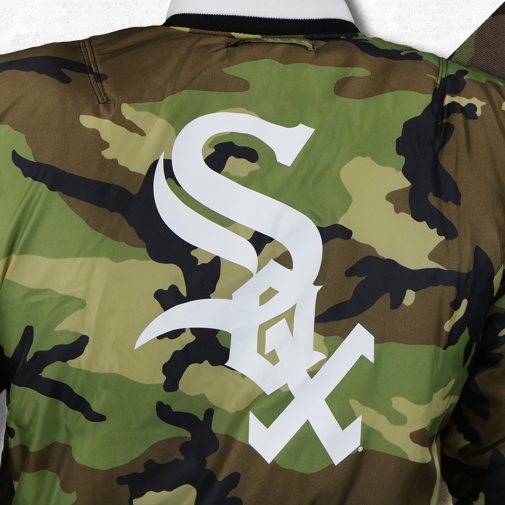 The White Sox Logo on the Chicago White Sox MLB Patch Alpha Industries Reversible Bomber Jacket With Camo Liner | Black Bomber Jacket